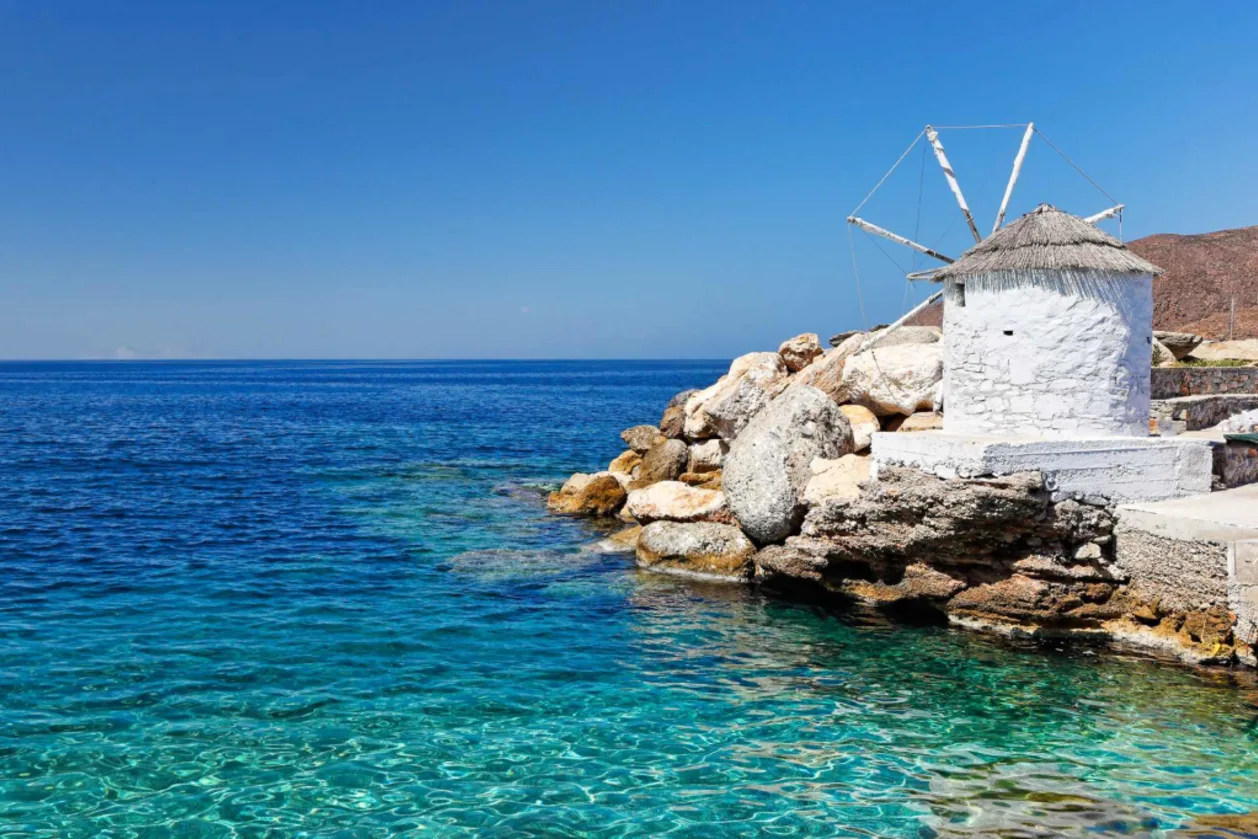 iconic white windmill on Amorgos coast underrated travel destination